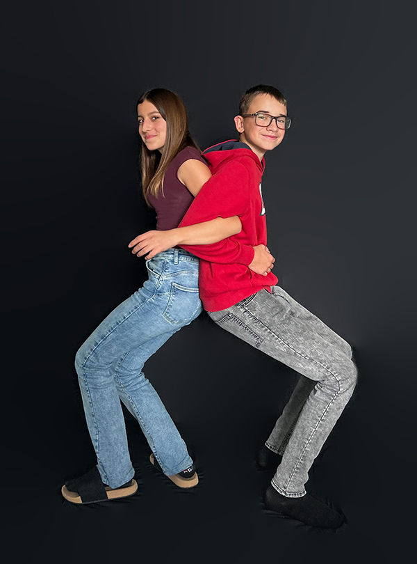 zwei Schüler posieren vor dem schwarzen Vorhang